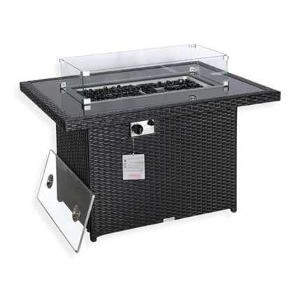 A black wicker fire table with a glass top and visible gas valve, set against a white background.
