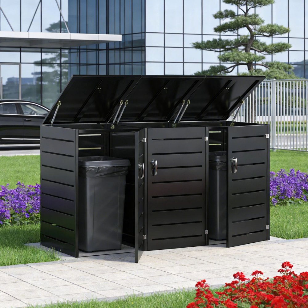 Black outdoor trash bin with hinged lid in a garden setting