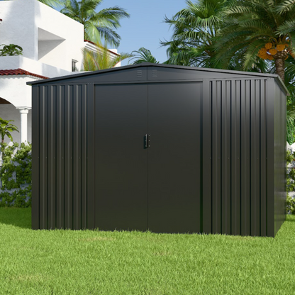 Black metal storage shed on grass with palm trees in the background