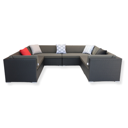 A U-shaped outdoor sectional sofa with handwoven PE rattan and a sturdy aluminum frame, featuring gray cushions and pillows, viewed from a slightly elevated angle.