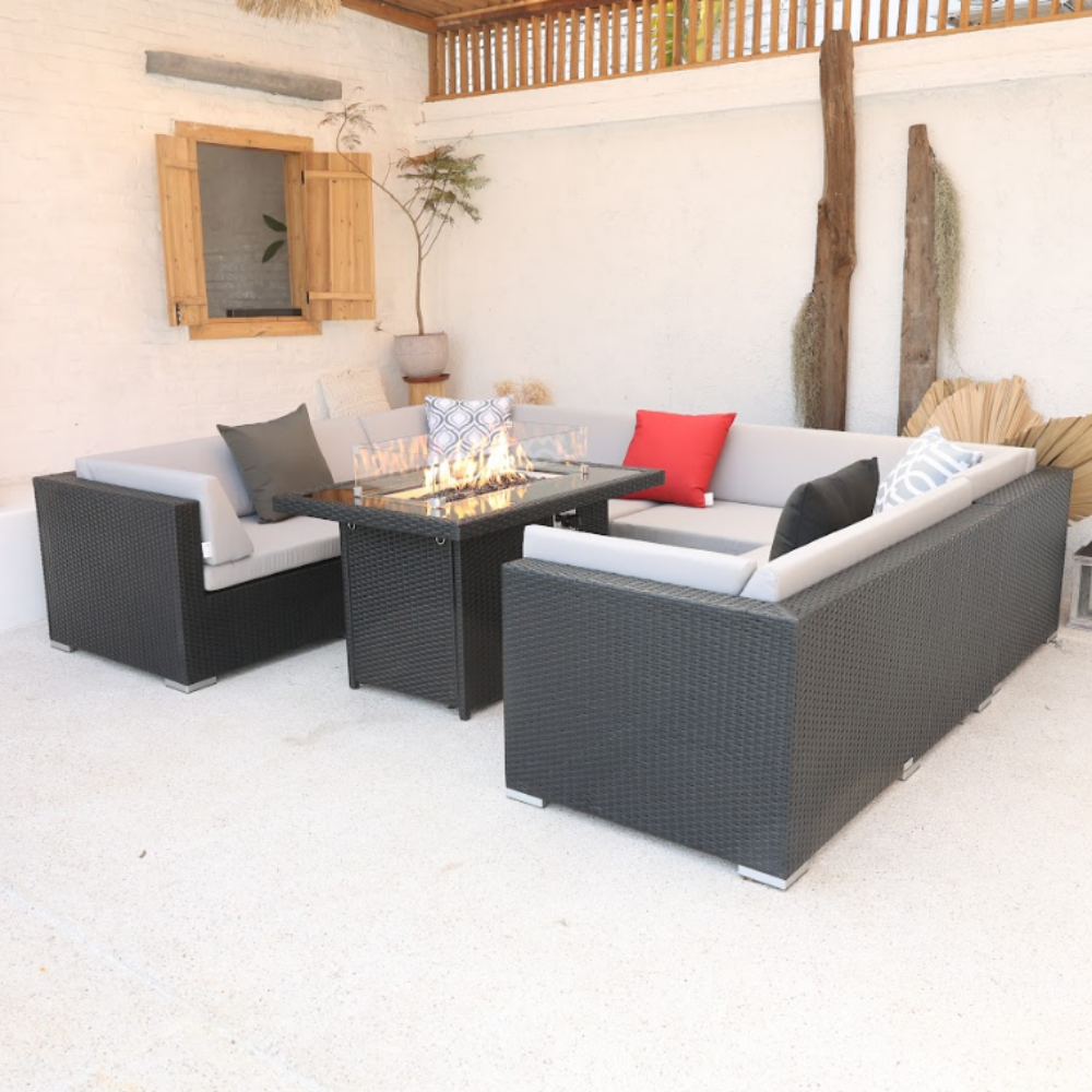 A U-shaped outdoor sectional sofa with handwoven PE rattan and a sturdy aluminum frame, featuring gray cushions and pillows, viewed from a slightly elevated angle.